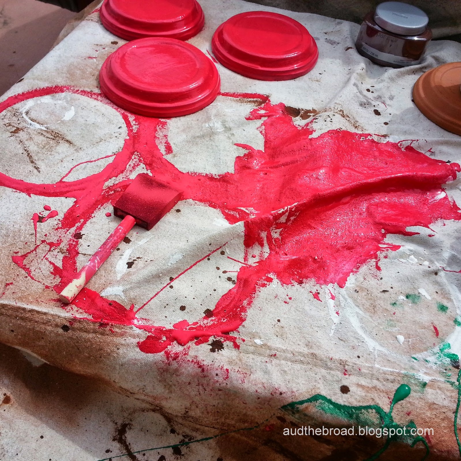 red paint spill on drop cloth