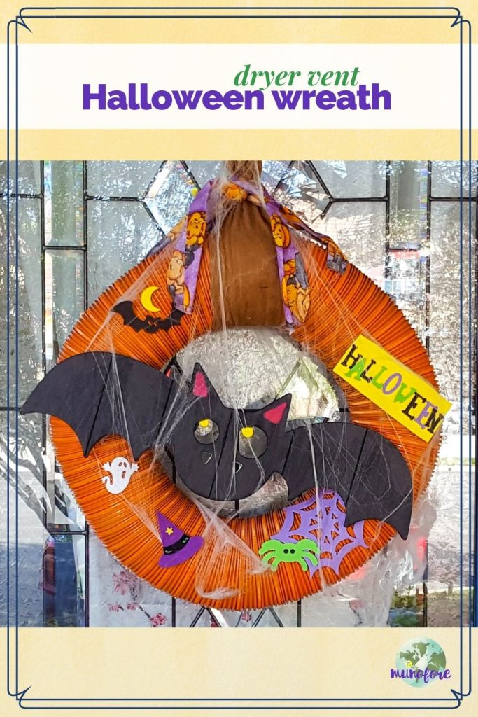 hallween wreath on a door with text overlay "dryer vent Halloween wreath"