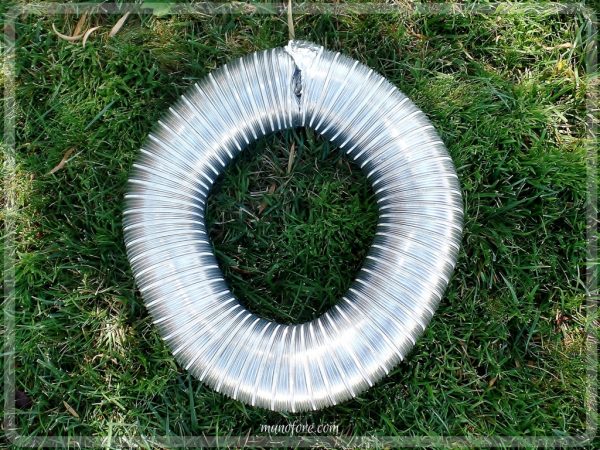 From trash to treasure - an old dryer vent becomes a festive Halloween wreath. Halloween craft, dryer vent pumpkin, easy Halloween decoration.