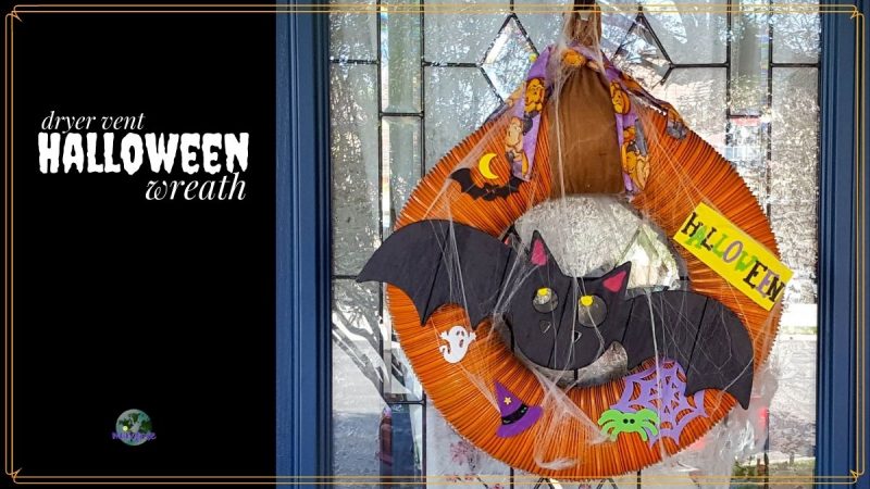 Halloween wreath on a doow with text overlay "dryer vent Halloween wreath"