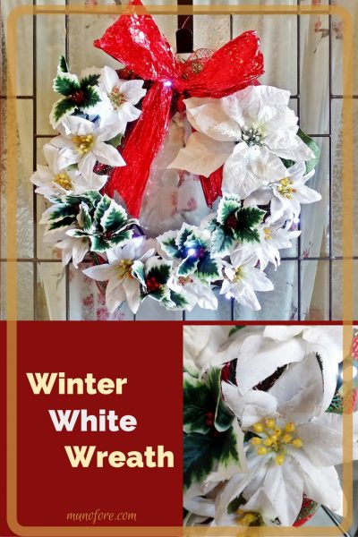 This Winter White Wreath features glitter covered silk poinsettias and contrasting green and red holly sprigs to greet family and friends this Christmas.