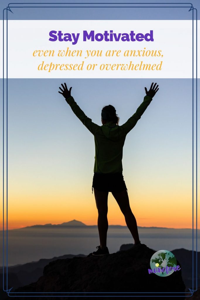 man on mountain with arms raised and text overlay "Stay Motivated even when you are anxious, depressed or overwhelmed"