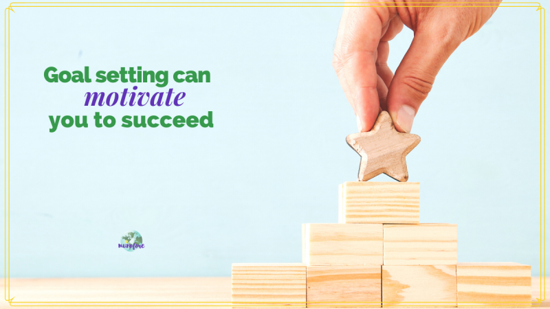 hand placing wooden star on top of wooden block pyramid and text overlay "goal setting can motivate you to succeed"