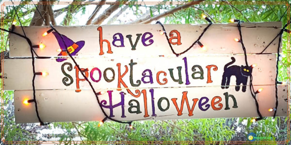 halloween sign hanging from porch