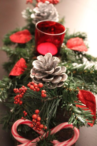 greenery with red candles and candy canes