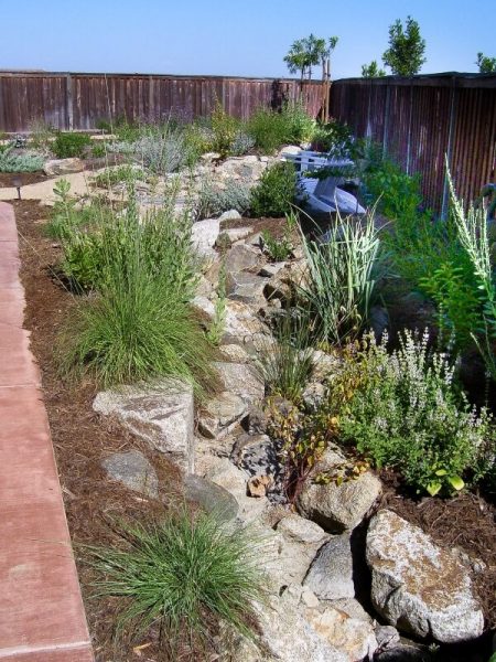 dry stream bed along a house