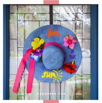 Decorated summer beach hat hung on a door