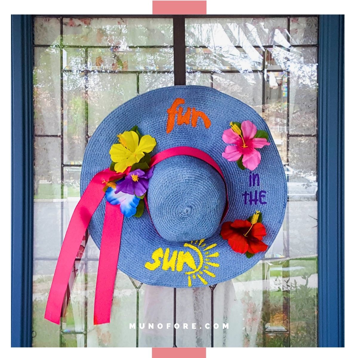 Decorated summer beach hat hung on a door