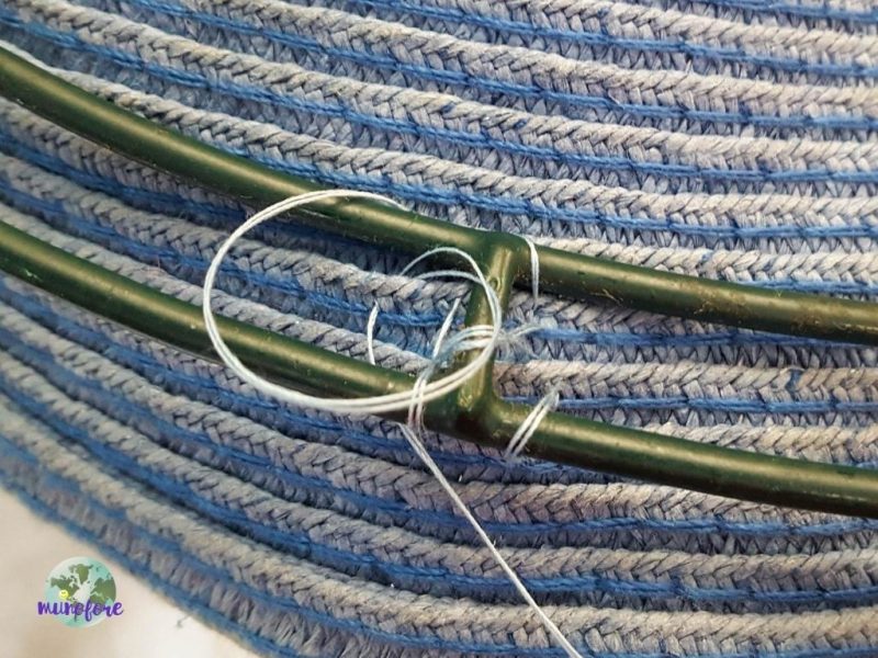 sewing a wire wreath frame onto a hat