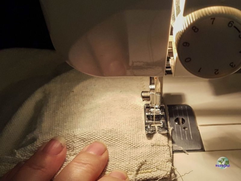 sewing a seam in drop cloth