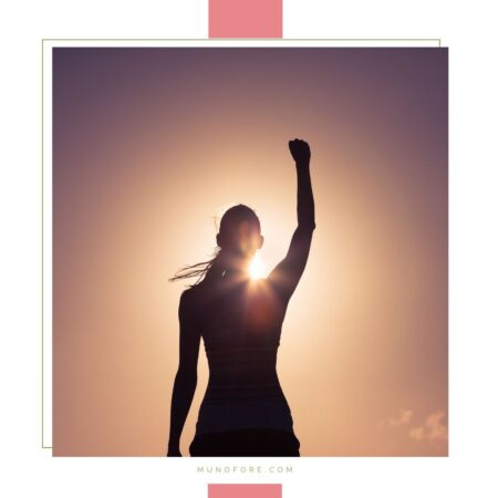 woman raising her hand in success