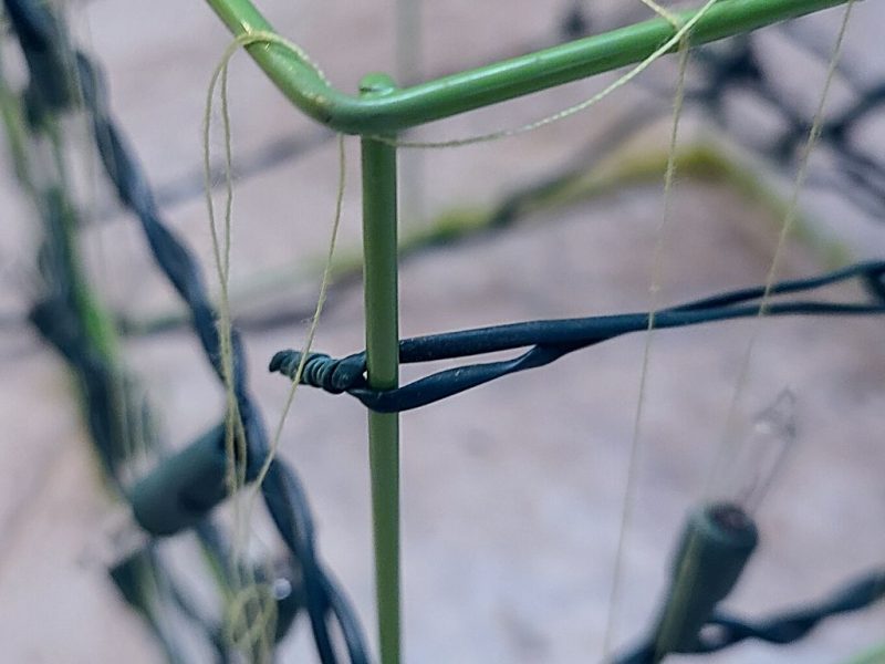 close up of twist tie on a wire box