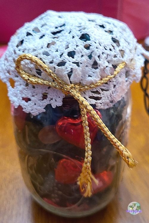 doily tied around a mason jar filled with potpourri