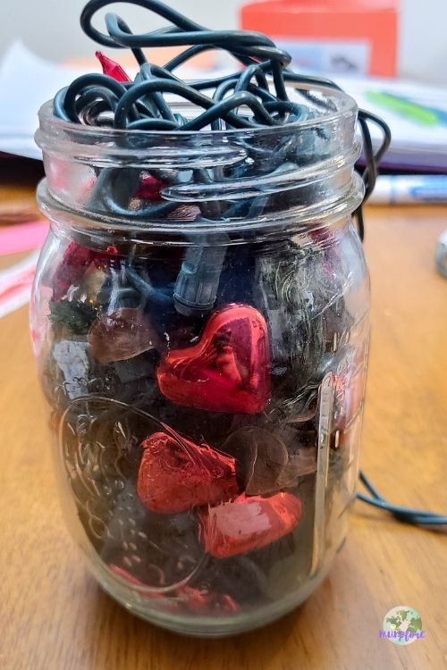 mason jar with heart shapes, potpourri and mini lights
