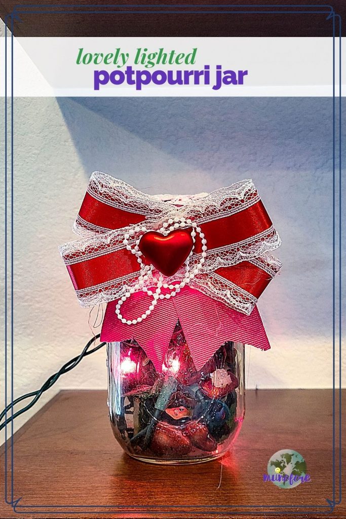 mason jar filled with potpourri and christmas lights with text overlay "lovely lighted potpourri jar"